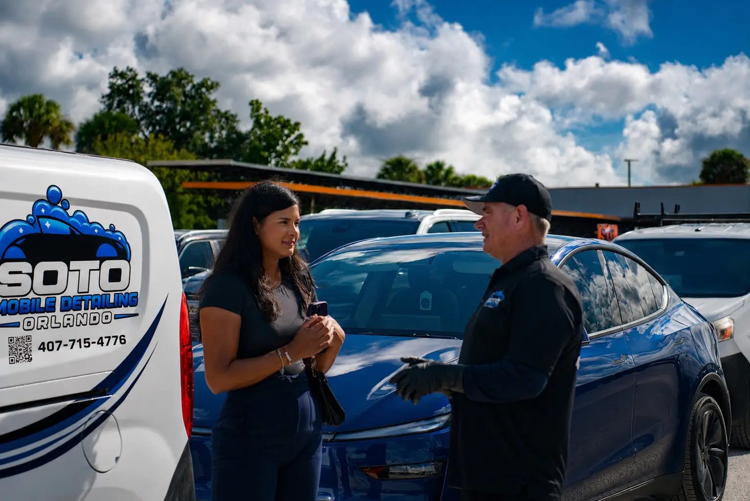 Mobile detailing company in Orlando, FL · detailer walking a customer around the finished vehicle