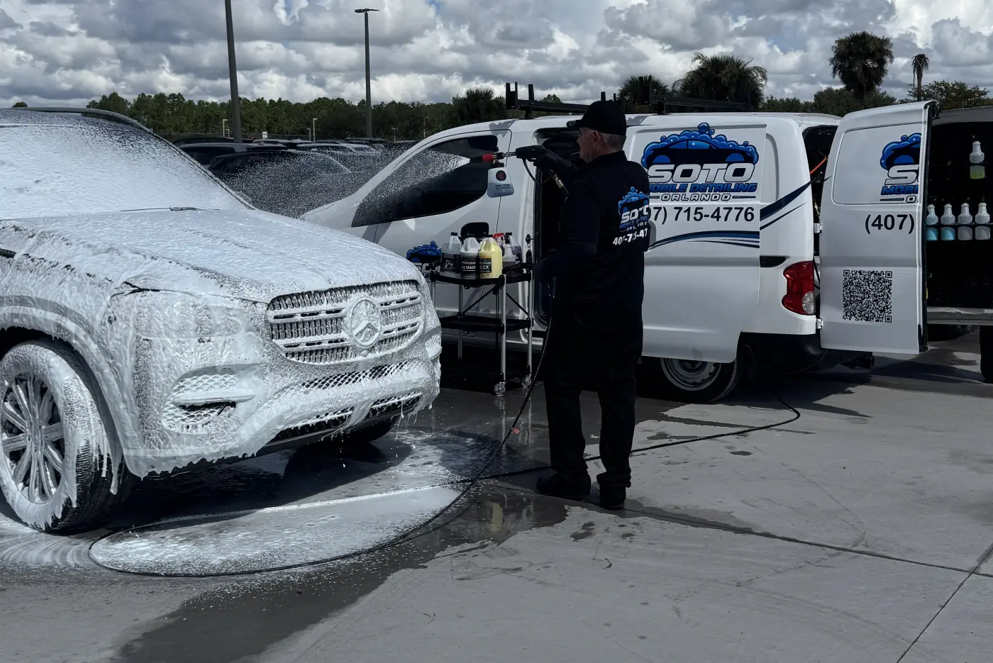 Mobile detailing company in Orlando, FL Mobile detailing in Altamonte Springs, FL · Mercedes SUV covered in foam pre-wash while a Soto detailer works beside the van