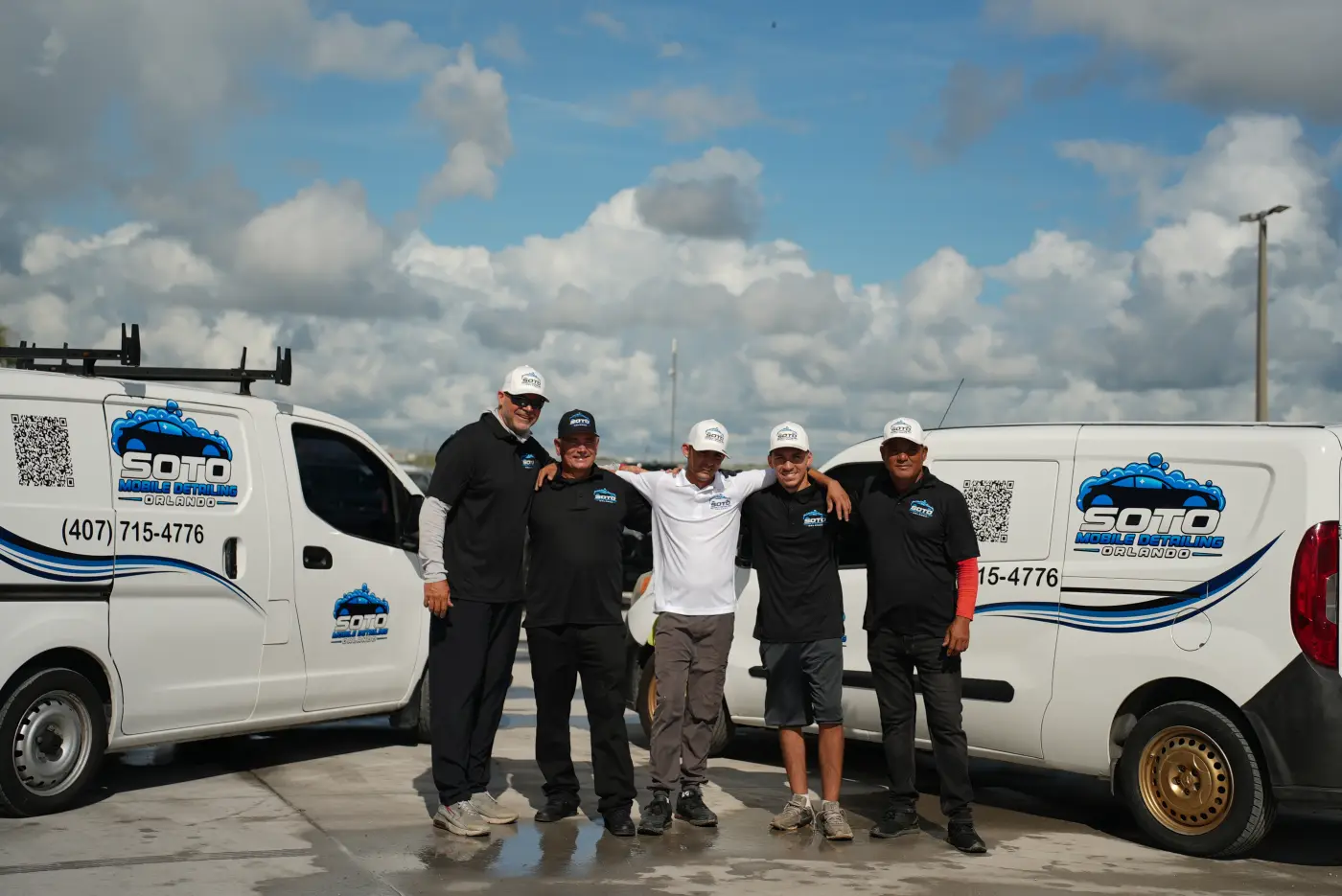 Mobile detailing company in Orlando, FL Mobile detailing in Dr. Phillips, Orlando FL · The Soto crew standing together between two branded Soto vans